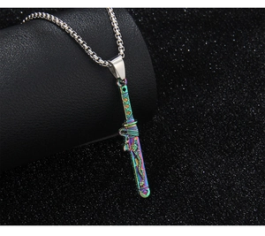 Macro detail of colorful sword pendant with dragon embossing on stainless steel chain