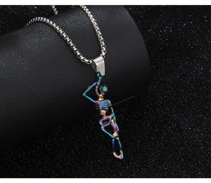 Macro shot of punk dancing skeleton pendant with iridescent rainbow finish and silver chain
