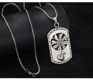 Detail view of rotating gear and money bag pendant on a vintage silver hip hop necklace