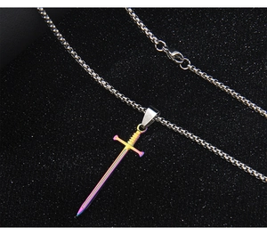 Detail of a rainbow gradient sword pendant with a silver box chain on black background