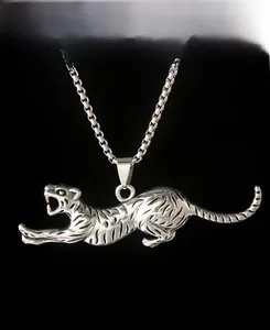 Macro shot of silver stainless steel cheetah pendant with detailed leopard texture