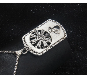 Detail of silver rectangular pendant featuring a rotary coin and yen symbol money bag design