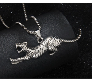 Detailed macro shot of a roaring leopard pendant in vintage silver on a box chain
