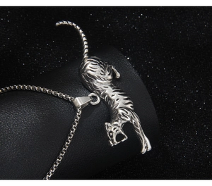 Detailed relief carving of a silver leopard pendant on a classic box chain necklace