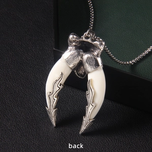 Vintage gothic dual wolf fang pendant necklace with silver metal floral back details