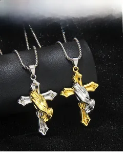 Detail of hip hop prayer hands and cross pendant with box chain on display stand
