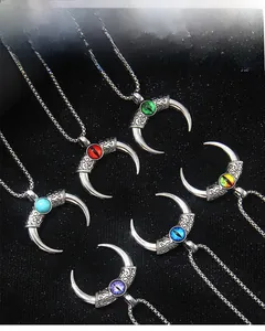 Detail of vintage stainless steel devil's eye horn pendants with six colorful resin eyes