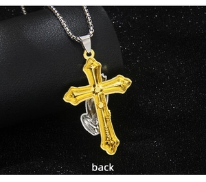 Detail view of the prayer hands and silver cross on the back of the gold necklace