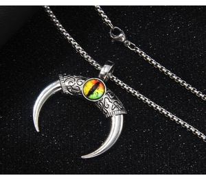 Macro shot of stainless steel crescent horn pendant with textured detail and evil eye inlay