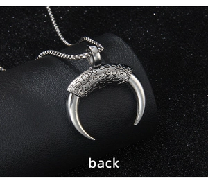 Macro view showing the detailed back engraving of the stainless steel horn pendant