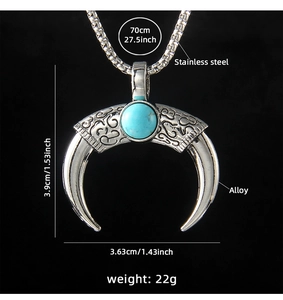 Macro shot of stainless steel crescent evil eye pendant with turquoise stone inlay