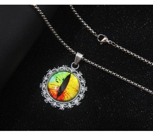Macro shot of evil eye pendant with vintage hollow pattern on black textured background