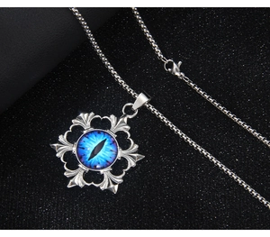 Macro detail of gothic stainless steel eye pendant with intricate floral engravings