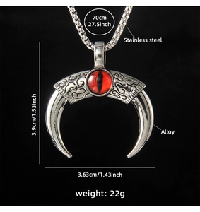 Detailed view of evil eye horn pendant with red gemstone and stainless steel chain