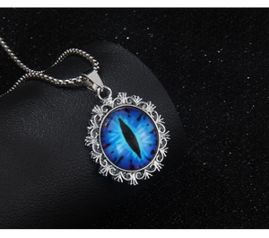 Detailed macro view of the evil eye pendant with blue resin eye and carved metal frame
