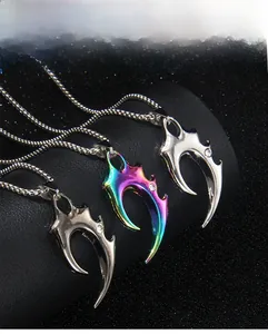 Detailed macro shot of gothic claw pendants in silver, gunblack and rainbow plating