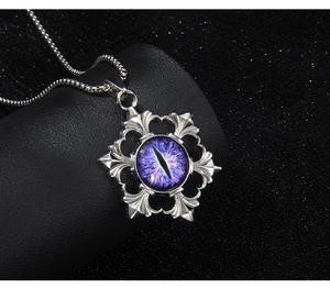 Macro detail of gothic evil eye pendant with purple bead and hexagonal snowflake frame