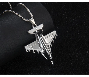 Detailed view of the silver fighter jet pendant with a sturdy metal square box chain