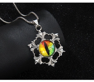Macro shot of gothic evil eye pendant with vibrant gradient glass and vintage silver frame