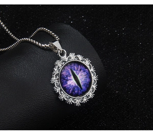 Detailed close-up of purple evil eye pendant on black leather display stand