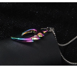 Macro detail of rainbow plated wolf tooth pendant with sparkling zircon on ball chain