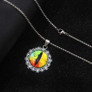 Unique stainless steel necklace featuring a colorful evil eye pendant on black texture