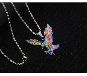 Macro shot of iridescent gradient eagle pendant with detailed wings on bead chain necklace