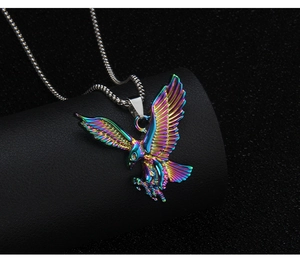 Close-up of rainbow eagle pendant in polished stainless steel on a black leather display