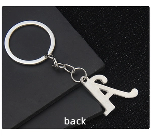 Polished silver metal letter A keychain showing a smooth back view on dark background