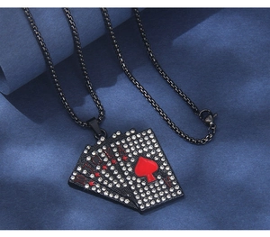 Macro shot of hip hop style black steel poker cards pendant with sparkling zircons