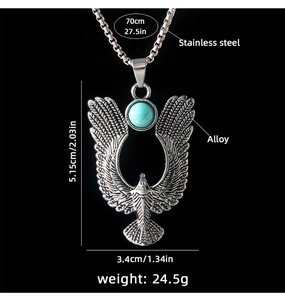 Detail of vintage eagle pendant with turquoise stone inlay and engraved feathers