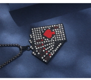 Macro shot of black poker card pendant necklace featuring A-10 royal flush with sparkling rhinestones