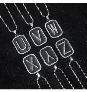 Detail of hip hop necklaces U-Z with black enamel and sparkling white rhinestones