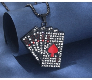 Macro detail of black stainless steel poker royal flush pendant with white rhinestones