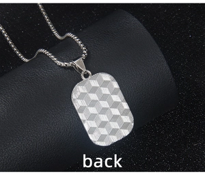Macro shot showing the back of a silver dog tag necklace with 3D cube texture