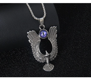 Detailed macro view of silver eagle pendant with purple eye gem on a box chain necklace