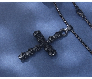 Close-up of gothic gun-black stainless steel skull cross pendant and box chain