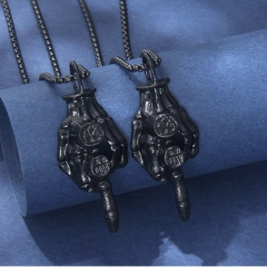 Detailed close-up of matte black skeleton hand necklaces with number 13 engraving