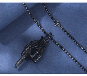 Detail of gothic skull hand pendant with box chain and lobster clasp in dark grey metal