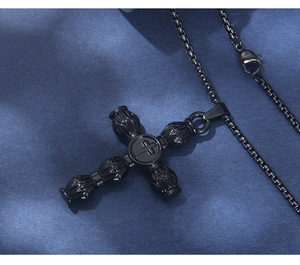 Close-up of black gothic cross pendant with 3D embossed texture and metal box chain