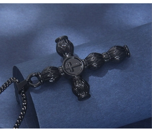 Detail of a vintage black stainless steel cross pendant with round bead chain necklace