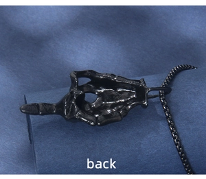 Detailed back view of gothic black plated skeleton hand pendant with matching box chain