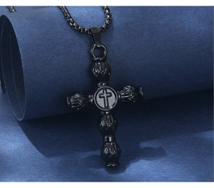 Detailed view of black stainless steel gothic cross pendant with textured engravings