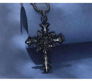 Macro view of gothic black stainless steel cross pendant with a detailed central rose