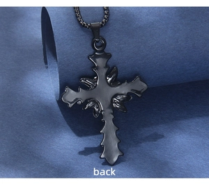Back view of a black gothic cross pendant with serrated edges and bead chain