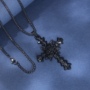 Gothic black stainless steel rose cross pendant necklace on a dark textured background