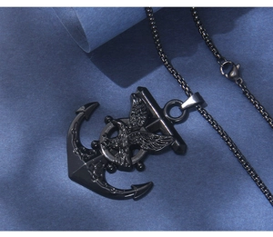 Detail of black stainless steel anchor pendant with eagle and ship helm on box chain