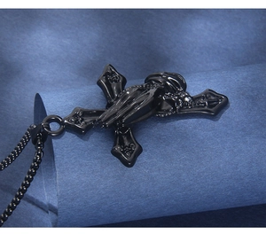 Close-up of black stainless steel praying hands cross pendant with matching bead chain