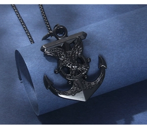 Detailed close-up of a black stainless steel nautical anchor and eagle pendant necklace