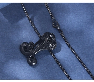 Detailed view of dark black mamba snake pendant with intricate scales on a box chain